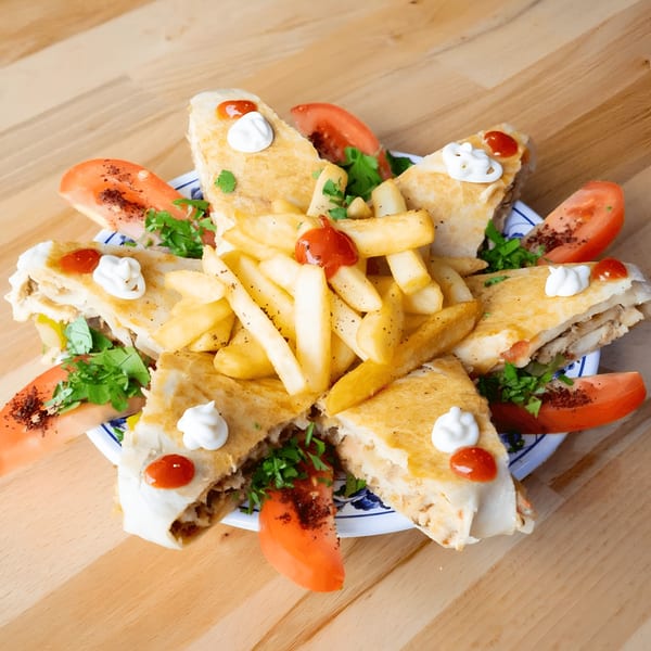 Ali Baba Kabab's Mediterranean dish with quesadilla-like wraps, french fries, tomatoes, and parsley.
